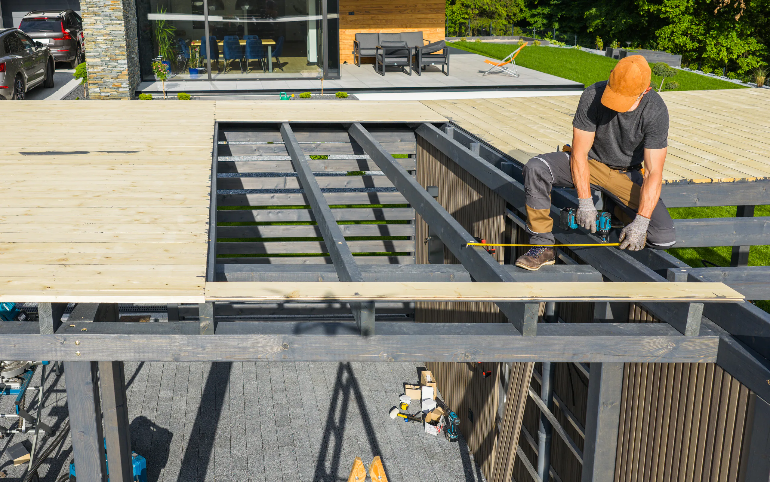 Carpenter measuring deck boards